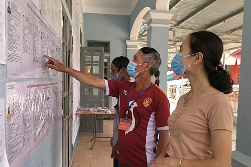 Cử tri ở khu vực bỏ phiếu số 4, bản Pa Kéo, thị trấn Nậm Nhùn nghiên cứu tiểu sử ứng cử viên. (Ảnh  Pư Ly)